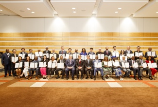 Commissioner General of Section for Jamaica’s Pavilion, Maureen Smith (11th left, back row), with representatives from other countries that will be participating in Expo 2025 Osaka, Kansai, Japan, during the recent International Participants Meeting in Japan where the official contract was signed.

