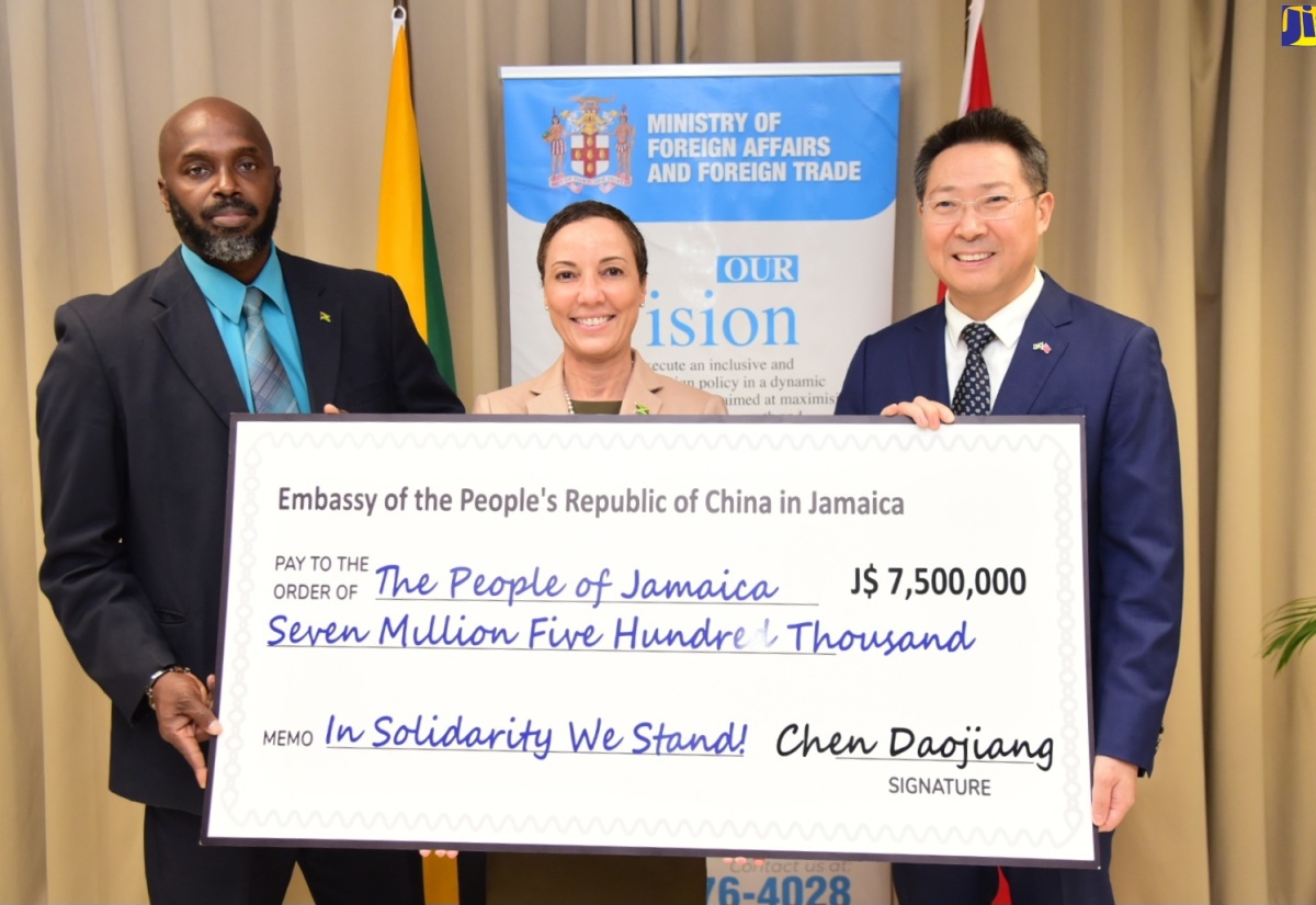 Minister of Foreign Affairs and Foreign Trade, Senator the Hon. Kamina Johnson Smith (centre), and Acting Director General of the Office of Disaster Preparedness and Emergency Management (ODPEM), Richard Thompson (left), receive a cheque valued at $7.5 million from Chinese Ambassador to Jamaica, Chen Daojiang, to assist Jamaica’s Hurricane Beryl recovery efforts.  The handover ceremony was held at the Ministry’s offices in downtown Kingston on Tuesday (July 16). 