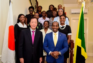 Minister of State in the Ministry of Foreign Affairs and Foreign Trade, Hon. Alando Terrelonge (right, front row), and Japan’s Ambassador to Jamaica, His Excellency Yasuhiro Atsumi (left, front row), share a photo opportunity with this year’s group of Jamaicans who will participate in the Japan Exchange and Teaching (JET) Programme, during a send-off reception on Friday (July 19). The reception was held at the Ambassador’s Official Residence on Paddington Terrace in St. Andrew. The group represents Jamaica’s 24th participating cohort.