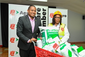Minister of Agriculture, Fisheries and Mining, Hon. Floyd Green (left), is presented with agricultural inputs to assist farmers impacted by the passage of Hurricane Beryl, by Deputy Chief Executive Officer of Hardware & Lumber, Olive Downer Walsh. Over $15.3 million in supplies were handed over at Hardware & Lumber Limited in Kingston on Wednesday (July 17). An additional $9.7 million will be allocated to broader recovery initiatives, including infrastructure repair and community rebuilding. 