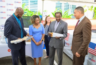 Prime Minister, the Most Hon. Andrew Holness (right), in discussion with United States (US) Ambassador to Jamaica, His Excellency Nickolas N. Perry (second right); USAID Acting Country Representative, Erin Taylor (centre); Minister without Portfolio with responsibility for Information, Skills and Digital Transformation, Senator Dr. the Hon. Dana Morris Dixon; and Acting Director General, Office of Disaster Preparedness and Emergency Management (ODPEM), Richard Thompson, during Tuesday’s (July 30) handover of emergency relief supplies, valued US$360,000, which were donated by the US to assist Jamaica’s Hurricane Beryl recovery efforts. The presentation was made at ODPEM’s Haining Road offices in Kingston. 

