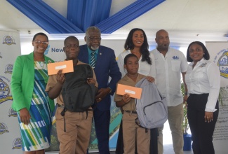 Education Officer, Ministry of Education & Youth, Yvonne Hardie (left), with two of the recipients of financial help and back-to-school supplies, from the Barracks Road Primary School, Ashawni Reid and Jermaine Garfield, at a treat held at Pier One in Montego Bay, St James, by New Fortress Energy, on Wednesday, July 31. Others (from second left) are  Custos of St. James, Bishop the Hon. Conrad Pitkin; Vice President, New Fortress Energy, Verona Carter; Deputy Mayor of Montego Bay, Councillor Dwight Crawford and Third Vice President, Montego Bay Chamber of Commerce and Industry (MBCCI), Paulette Neil. 