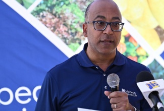 Caribbean Chemicals Jamaica's Managing Director, Graham Dunkley, addresses a function for the hand over of agricultural inputs to farmers in St. Elizabeth at  M&K Farm Supplies in Nain on Thursday, July 25.