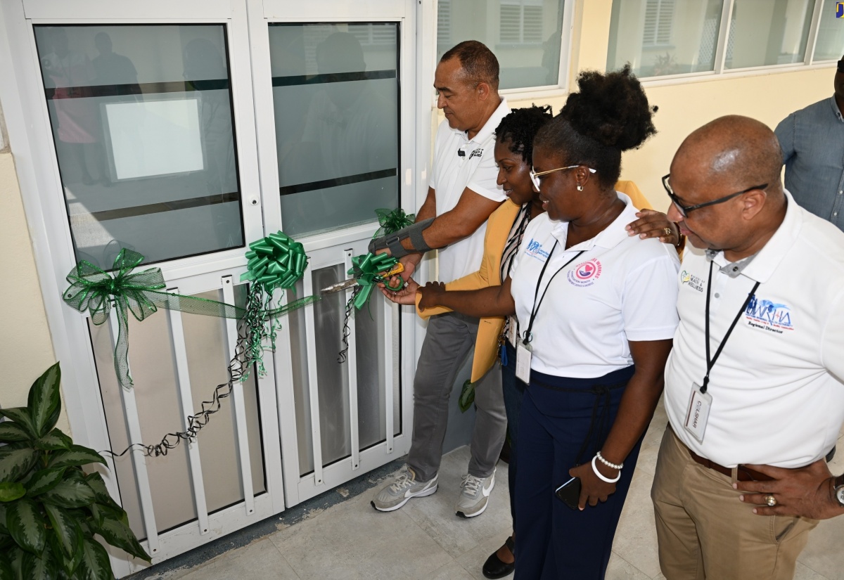 Minister of Health and Wellness, Dr. the Hon. Christopher Tufton (left), cuts the ribbon to officially open a newly renovated operating theatre at the Falmouth Public General Hospital in Trelawny on Friday (July 26). He is joined by (from 2nd left), Parish Manager for Trelawny Health Services, Keriesa Bell Cummings; Chief Executive Officer (CEO) of the Falmouth Public General Hospital, Princess Wedderburn; and Regional Director, Western Regional Health Authority (WRHA), Andrade Sinclair. 