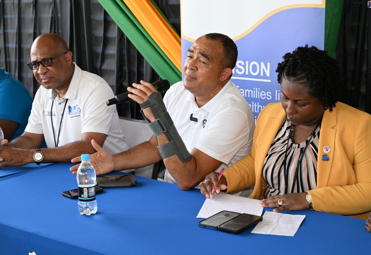 Minister of Health and Wellness, Dr. the Hon. Christopher Tufton (centre), addresses a vector-control team in Trelawny at the Falmouth Public General Hospital, on Friday, July 26. With the Minister are Parish Manager of the Trelawny Health Services, Keriesa Bell Cummings and Regional Director of the Western Regional Health Authority (WRHA), Andrade Sinclair.


