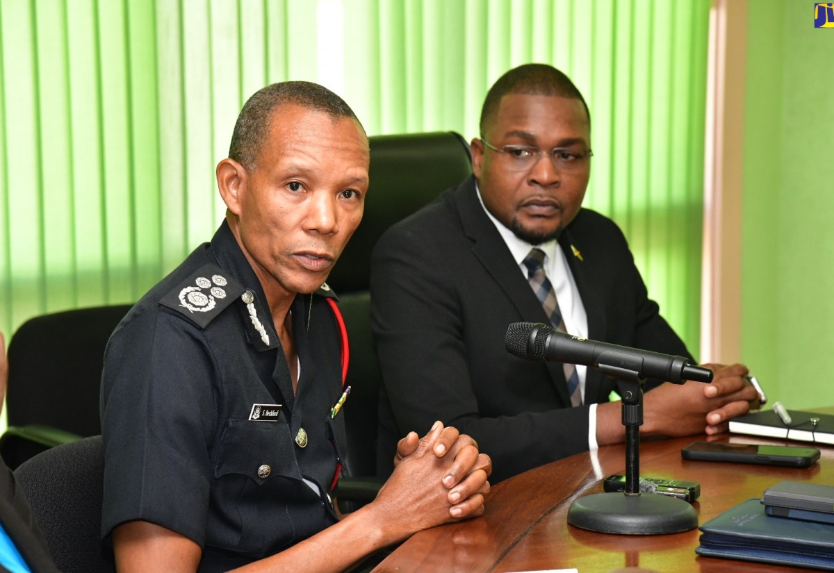 Commissioner of the Jamaica Fire Brigade (JFB), Stewart L. Beckford (left), addresses a meeting of the National Disaster Risk Management Council at the Ministry of Local Government and Community Development in Kingston on Monday (July 1). Looking on is Minister without Portfolio in the Ministry of Economic, Growth and Job Creation with the responsibility for Works, Hon. Robert Nesta Morgan.