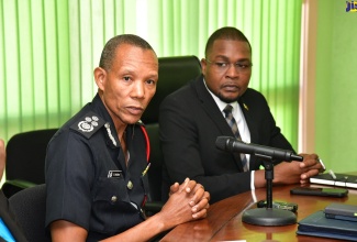 Commissioner of the Jamaica Fire Brigade (JFB), Stewart L. Beckford (left), addresses a meeting of the National Disaster Risk Management Council at the Ministry of Local Government and Community Development in Kingston on Monday (July 1). Looking on is Minister without Portfolio in the Ministry of Economic, Growth and Job Creation with the responsibility for Works, Hon. Robert Nesta Morgan.
