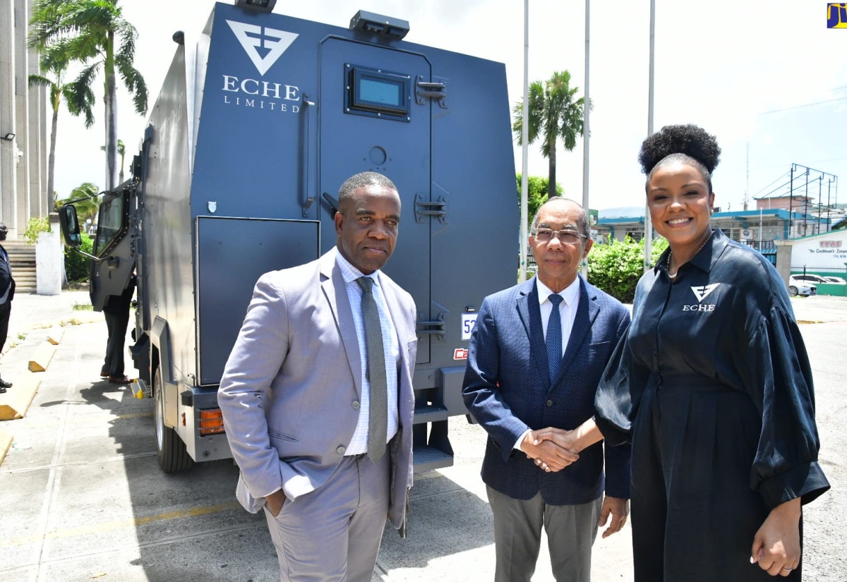 Deputy Prime Minister and Minister of National Security, Hon. Dr. Horace Chang (centre), shakes hands with Founder and Chief Executive Officer (CEO) of ECHE Limited, Lititia Myers Gray (right), during a visit by Ms. Gray to the Ministry’s offices in Kingston on Wednesday (July 17), to showcase the company’s newly acquired fleet of armored vehicles. Sharing the moment is Commissioner of Police, Dr. Kevin Blake.

