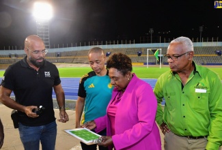 Minister of Culture, Gender, Entertainment and Sport, Hon. Olivia Grange (second right), discusses the new lighting system at the National Stadium with (from left) Chief Executive Officer (CEO) of Phase 3 Productions, Delano Forbes; General Secretary of the Jamaica Football Federation (JFF), Dennis Chung; and General Manager of Independence Park Limited, Major Desmon Brown. Occasion was the testing of new lights at the stadium in Kingston on Wednesday (July 24).