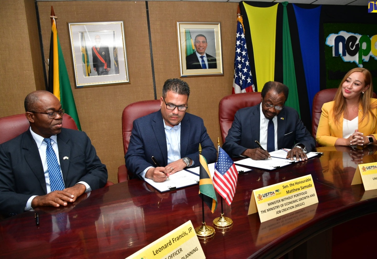 Minister without Portfolio in the Ministry of Economic Growth and Job Creation, Senator the Hon. Matthew Samuda (second left), and United States (US) Ambassador to Jamaica, His Excellency N. Nickolas Perry, sign a $61-million grant agreement between the National Environment and Planning Agency (NEPA) and the United States Trade and Development Agency (USTDA) for technical assistance to undertake a study on the impact of reverse osmosis technology on the environment.  Observing (from left) are Chief Executive Officer, NEPA, Leonard Francis, and Country Manager, Andean Region and Caribbean, USTDA, Lambrini Kolios. The signing took place at NEPA’s head office in Kingston on Wednesday (July 31).