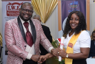 Regional Director of Region 1, Otis Brown (left), presents Moneke Mattocks with her certificate at the Jamaica-Tertiary Education Commission’s (J-TEC) Food Service Worker Certification Ceremony at George Headley Primary School in Kingston on Friday (July 12). The event saw the award of certificates to school-based food service workers who participated in a pilot project to certify individuals through the Prior Learning Assessment Recognition (PLAR) programme. The initiative aligns with the Ministry of Education and Youth’s emphasis on the development of persons through certification.