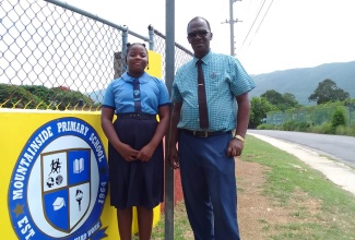 Principal of Mountainside Primary School in St. Elizabeth, Eric McLean, and Head Girl, Tiandra Lee. 