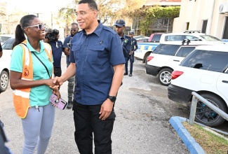 Prime Minister, the Most Hon. Andrew Holness, interacts with Parish Coordinator for Disaster Preparedness at the St. Elizabeth Municipal Corporation, Ornella Lewis, during a tour of the parish on Thursday, (July 4) to assess the aftermath of Hurricane Beryl.