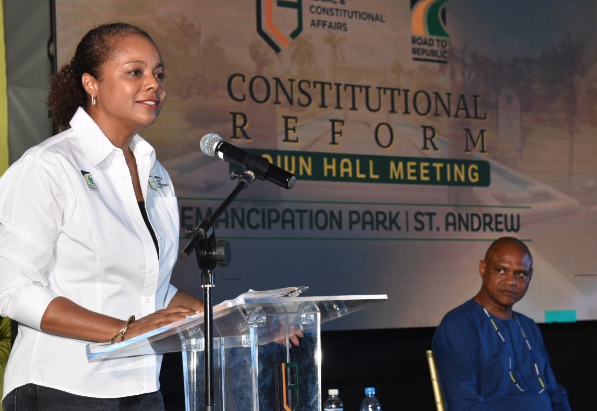 Minister of Legal and Constitutional Affairs, Hon. Marlene Malahoo Forte,  addresses the audience at the Road to Republic Town Hall, held at Emancipation Park in New Kingston on Thursday (July 25). Listening is Deputy Dean, Faculty of Law, University of the West Indies, Mona Campus, Dr. Christopher Malcolm.