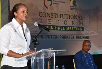 Minister of Legal and Constitutional Affairs, Hon. Marlene Malahoo Forte,  addresses the audience at the Road to Republic Town Hall, held at Emancipation Park in New Kingston on Thursday (July 25). Listening is Deputy Dean, Faculty of Law, University of the West Indies, Mona Campus, Dr. Christopher Malcolm.