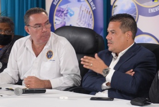 Minister of Science, Energy, Telecommunications and Transport, Hon. Daryl Vaz (left), and Minister Without Portfolio in the Ministry of Economic Growth and Job Creation, Senator the Hon. Matthew Samuda, converse during a press conference at the Petroleum Corporation of Jamaica (PCJ) in New Kingston on Friday (July 5) to provide an update on the restoration of utilities affected by Hurricane Beryl.