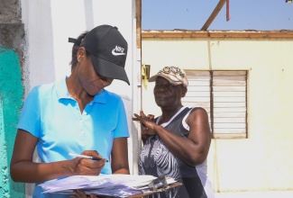 Ministry of Labour and Social Security Records Officer, Stacey-Ann Coleman (left), documents information being provided by resident of Mitchell Town in Clarendon, Novlette Rhoden, on the extent of damage sustained during Hurricane Beryl’s passage. The occasion was a visit to the community by teams from the Ministry on Wednesday (July 10) to assess damage and present relief items to affected residents.


