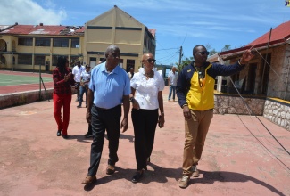 Minister of Education and Youth, Hon. Fayval Williams (centre) and Minister of State in the Ministry of Agriculture, Fisheries and Mining and Member of Parliament for St. Elizabeth South Eastern, Hon. Franklin Witter (left), are led on a tour of Munro College, St. Elizabeth, by Principal, Mark Smith, on July 24.  The school was among eight institutions in the parish that were severely damaged by  Hurricane Beryl.  At left in the background is Regional Director at the Ministry of Education and Youth – Region 5, Susan Nelson Smith. 