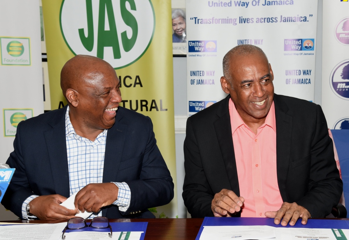 Chairman of the United Way of Jamaica, Dr. Devon Smith (left), sharing pleasantries with Senior Strategist, Ministry of Agriculture, Fisheries and Mining, Michael Pryce, during the launch of the farmers’ rehabilitation fund, at the Private Sector Organisation of Jamaica offices in St. Andrew, on July 12.
