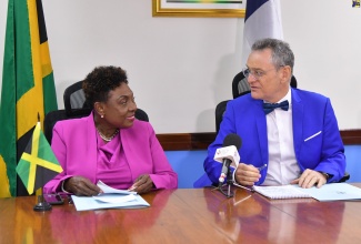 Minister of Culture, Gender, Entertainment and Sport, Hon. Olivia Grange, converses with France’s Ambassador to Jamaica, His Excellency Olivier Guyonvarch, during the signing of a Memorandum of Understanding (MOU) for Bilateral Cooperation in the Field of Sport, at the Ministry in Kingston on Wednesday (July 24). Areas covered under the MOU are the sharing of experiences and developing joint initiatives in sports; promoting common standards for the organisation of major sporting events; sharing common objectives and know-how; developing high sports performance through the exchange of good practices, coaching training, and research; sharing information on the development of the sports economy and sports tourism; and promoting sports ethics, mainly the fight against doping.  