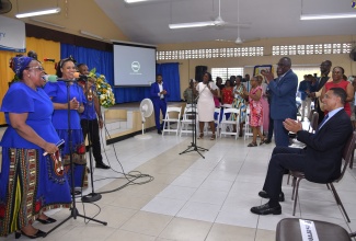 Members of the Ensom City Gospel Chapel Singers (left), extend birthday greetings in song to Prime Minister, the Most Hon. Andrew Holness (right, seated), during the Assembly’s 50th Anniversary Service on Sunday (July 21). Prime Minister Holness delivered remarks during the service, which was held at the church located in St. Catherine.

