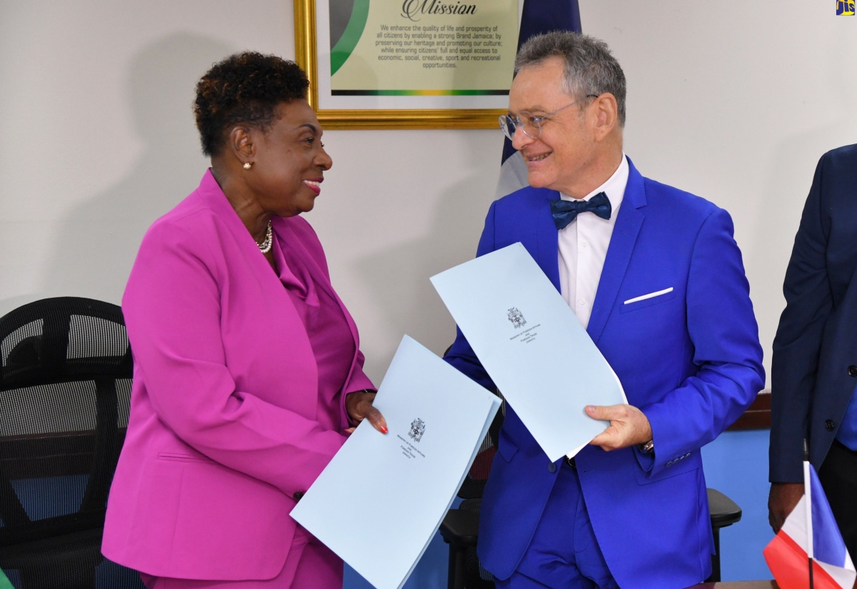 Minister of Culture, Gender, Entertainment and Sports, Hon. Olivia Grange; and Ambassador of the People’s Republic of France, His Excellency Olivier Guyonvarch, shake hands following the signing of a Memorandum of Understanding (MOU) on July 24 at the Ministry’s office, 4-6 Trafalgar Road in Kingston. The MOU was signed to strengthen cooperation in Sports between Jamaica and the People’s Republic of France.