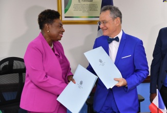 Minister of Culture, Gender, Entertainment and Sports, Hon. Olivia Grange; and Ambassador of the French Republic, His Excellency Olivier Guyonvarch, shake hands following the signing of a Memorandum of Understanding (MOU) on July 24 at the Ministry’s office, 4-6 Trafalgar Road in Kingston. The MOU was signed to strengthen cooperation in Sports between Jamaica and France.