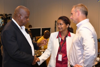 Minister of State in the Ministry of Agriculture, Fisheries and Mining, Hon. Frank Witter (left), engages with Senior Environmental Officer, Jamaica Bauxite Institute (JBI), Shanti Persaud, and District Manager-Closure, Rio Tinto, Fraser Thomson,  during the Jamaica Bauxite Institute (JBI) International Workshop on Bauxite Residue and Mud Disposal Legacy Issues, at the ROK Hotel in downtown Kingston, on July 15.