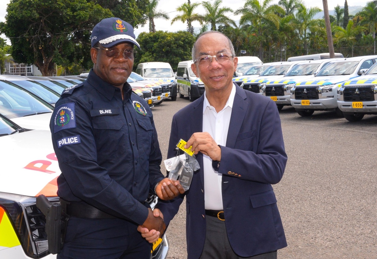 Minister of National Security, Hon. Dr. Horace Chang (right), hands over keys to 40 new vehicles, valued over $313 million, to Commissioner of Police, Dr. Kevin Blake, at a handover ceremony, held on July 31 at the Office of the Commissioner in St. Andrew.