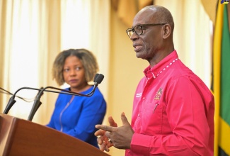 Minister of Local Government and Community Development, Hon. Desmond McKenzie (right), addressing Wednesday’s (July 10) post-Cabinet press briefing at Jamaica House. Looking on is Minister without Portfolio in the Office of the Prime Minister with responsibility for Information, Skills and Digital Transformation, Senator Dr. the Hon. Dana Morris Dixon.

