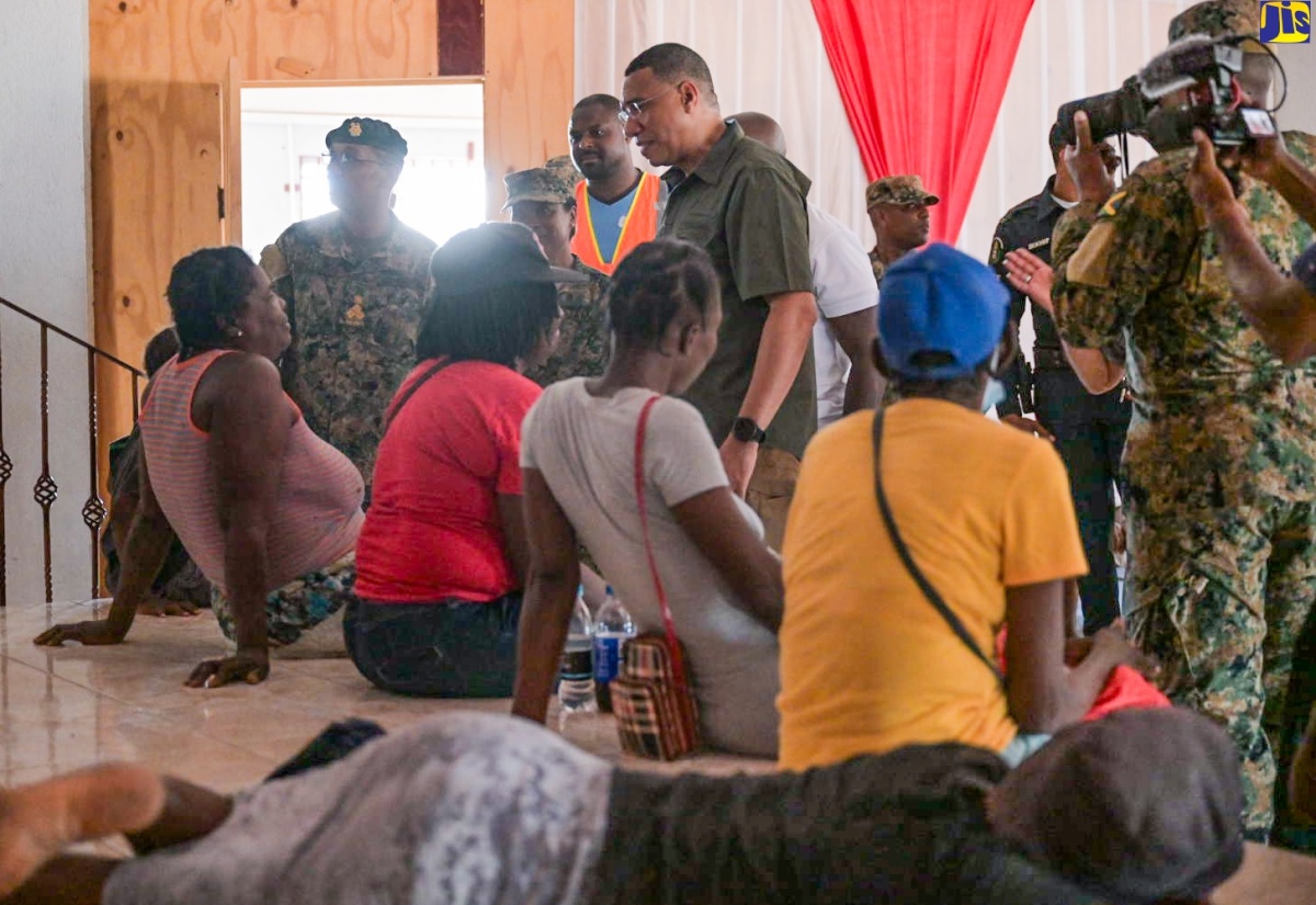 Prime Minister the Most Hon. Andrew Holness (centre) interacts with residents of Rocky Point Clarendon, during a visit to the area today (July 13).  The Jamaica Defence Force, including members of the Disaster Assistance Relief Team (DART), has been on the ground providing emergency assistance, clearing debris, and restoring essential services, following the passage of Hurricane Beryl on July 3.