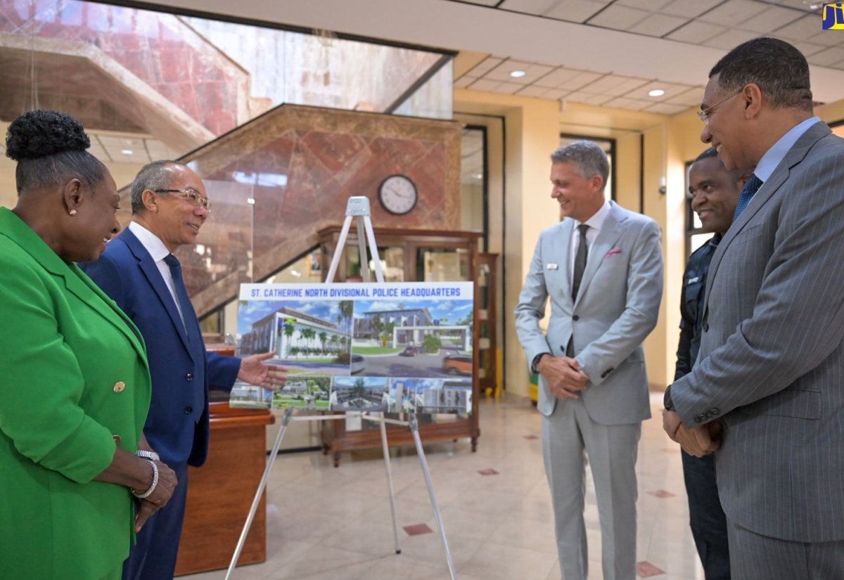 Prime Minister, the Most Hon. Andrew Holness (right), examines the design for the new St. Catherine North Divisional Headquarters of the Jamaica Constabulary Force (JCF), at the Office of the Prime Minister in St. Andrew, on July 23, at the contract-signing ceremony. Also looking at the design (from left) are Minister of Culture, Gender, Entertainment and Sport and Member of Parliament for St. Catherine Central, Hon. Olivia Grange; Deputy Prime Minister and Minister of National Security, Hon. Dr. Horace Chang; Chairman, West Indies Home Contractors (WIHCON) Limited, Peter Melhado; and Commissioner of Police, Dr. Kevin Blake.

