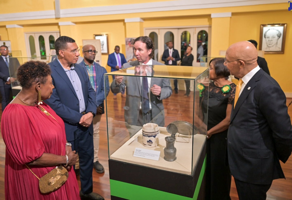 Their Excellencies, Governor- General, the Most Hon. Sir Patrick Allen (right) and Lady Allen (second right), are joined by Prime Minister the Most Hon. Andrew Holness (second left) and Minister of Culture, Gender, Entertainment and Sport, Hon. Olivia Grange (left), in viewing the display of Jamaican artefacts mounted in the ballroom at King’s House on Thursday (July 25), at the Governor- General’s Independence Reception and Exhibition. Providing details about the items on display is Director of National Museum Jamaica,  Dr. Jonathan Greenland.