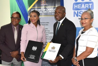 Minister of Labour and Social Security, Hon. Pearnel Charles Jr (second right) and Managing Director of the HEART/NSTA Trust, Dr. Taneisha Ingleton (second left), display copies of the Memorandum of Understanding (MOU) between the entities, which is aimed at enhancing workforce employability. The signing took place at the Ministry’s North Street offices in Kingston on Friday (July 26). Sharing the moment are State Minister, Dr. the Hon. Norman Dunn and Permanent Secretary in the Ministry, Colette Roberts Risden. The agreement aims to foster a robust and dynamic labour market by equipping workers with employment readiness training and other skillsets required to succeed in the local and global workspace.