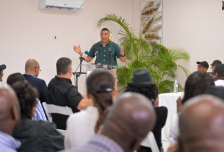 Prime Minister, the Most Hon. Andrew Holness (at the podium), addresses a meeting of the Negril Chamber of Commerce and other stakeholders in Negril on July 12.
