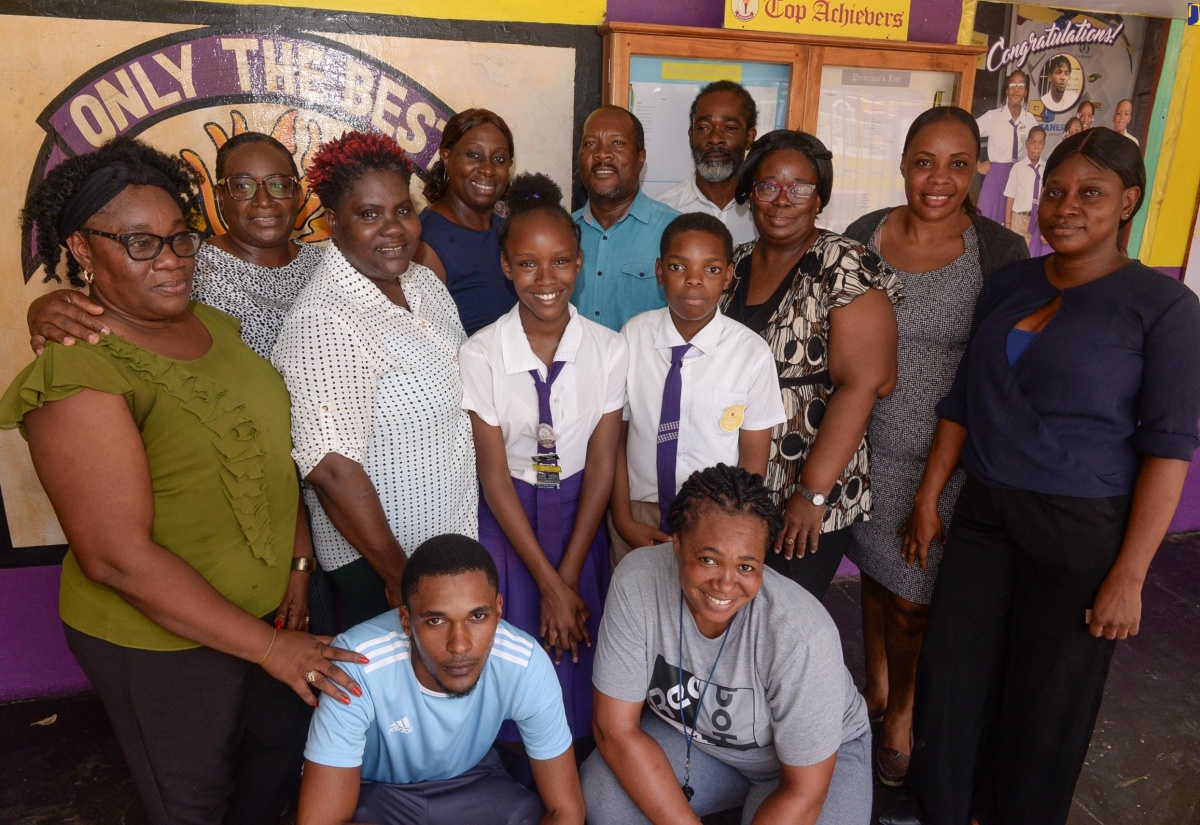 Teachers at the St. Catherine-based Crescent Primary School celebrate with their two top students, Kellisya Charles (third left) and Nathan Gersham (fourth left), at the school recently.