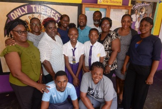 Teachers at the St. Catherine-based Crescent Primary School celebrate with their two top students, Kellisya Charles (third left) and Nathan Gersham (fourth left), at the school recently.
