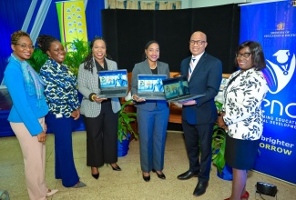 Minister of State in the Ministry of Education and Youth, Hon. Marsha Smith (third right); Permanent Secretary in the Ministry, Dr. Kasan Troupe (third left); and Chief Executive Officer, e-Learning Jamaica, Andrew Lee (second right), display some of the new laptops donated by e-Learning Jamaica to the Jamaica Library Service (JLS) at the Kingston and St. Andrew Parish Library, 2 Tom Redcam Drive, on Tuesday (August 13). Others from left are Senior Director, JLS, Kishma Simpson; Principal Director, Telecommunications, Ministry of Science, Energy, Telecommunications and Transport, Kaydian Smith Newton; and Director General, JLS, Maureen Thompson.

 

 