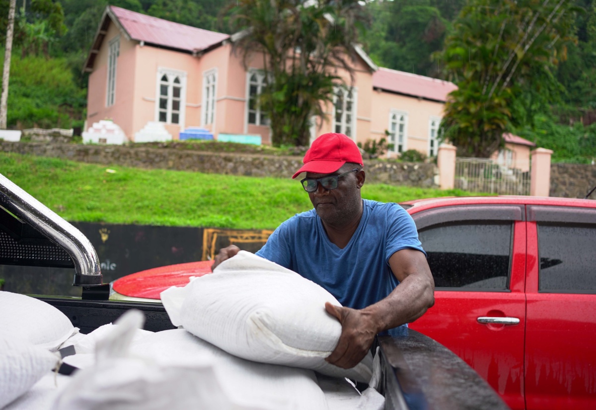 A St Andrew coffee farmer collects his bag of fertilizer provided by JACRA for his farm.

