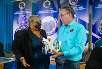 Minister of Science, Energy, Telecommunications and Transport, Hon. Daryl Vaz, in discussion with Permanent Secretary in the Ministry, Carol Palmer, at a special hybrid press conference at the Petroleum Corporation of Jamaica (PCJ) in New Kingston, on August 21.

