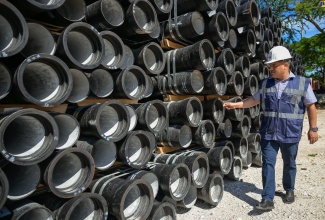 Minister without Portfolio in the Ministry of Economic Growth and Job Creation, Senator the Hon. Matthew Samuda, inspects pipes designated for a major water infrastructure project at the Mona Reservoir in St. Andrew, during a visit to the facility on Wednesday (August 28).

