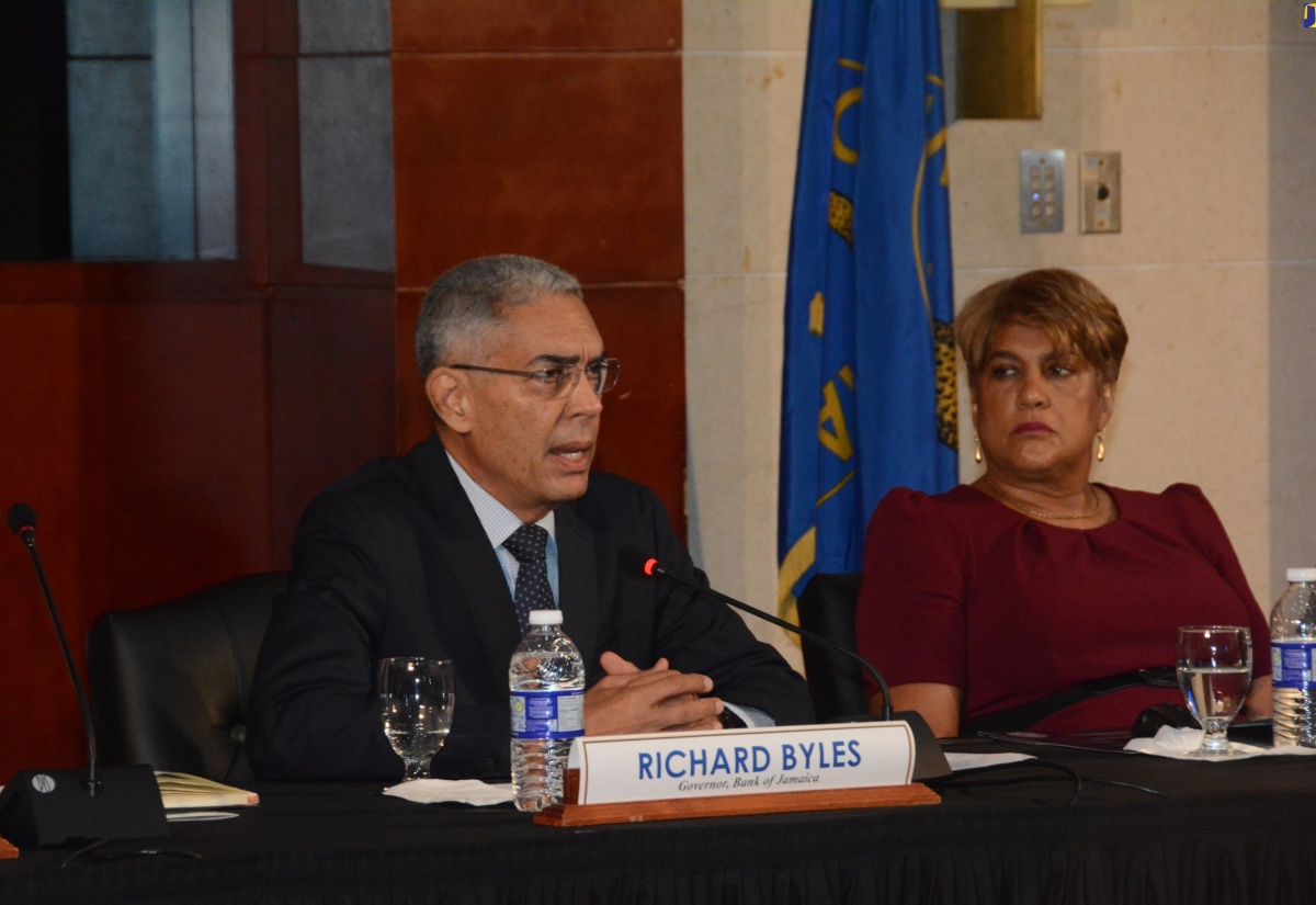 Bank of Jamaica (BOJ) Governor, Richard Byles, addresses journalists during the BOJ’s Quarterly Monetary Policy Report press conference at the Montego Bay Convention Centre on Wednesday (August 21). Listening is BOJ Deputy Governor in charge of Financial Markets and Payments Systems, Natalie Haynes.    

