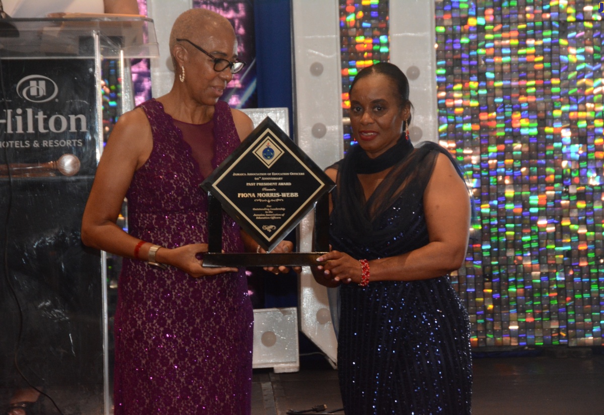 Minister of Education and Youth, Hon. Fayval Williams (left), presents an award for outstanding leadership to Immediate Past President of the Jamaica Association of Education Officers (JAEO), Fiona Morris-Webb, during the organisation’s 60th Anniversary Banquet and Inauguration Ceremony on Thursday (August 22) at the Hilton Rose Hall Resort and Spa in St. James.