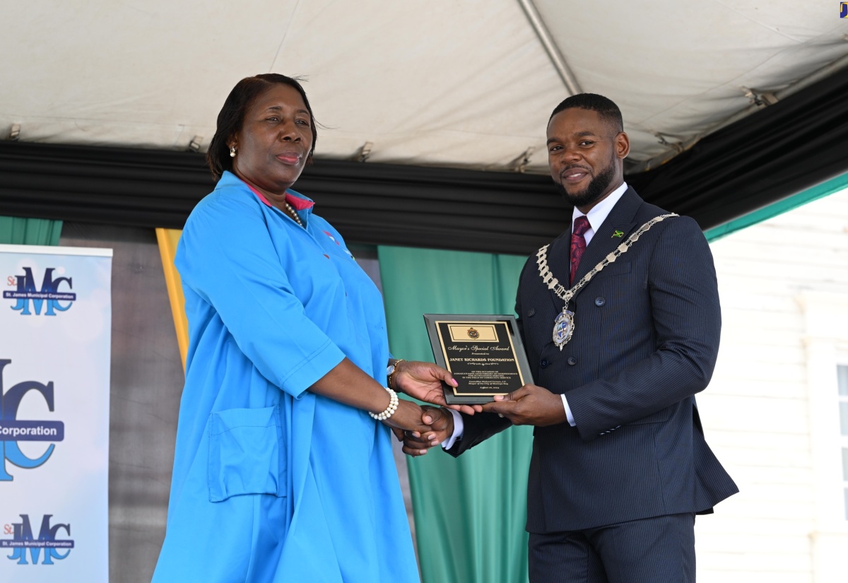 Mayor of Montego Bay and Chairman of the St. James Municipal Corporation, Councillor Richard Vernon, presents the Spirit of Independence Award to philanthropist  Janet Richards, Founder and President of the Janet Richards Foundation, during the St. James Independence Day civic ceremony at Sam Sharpe Square in Montego Bay on August 6.

