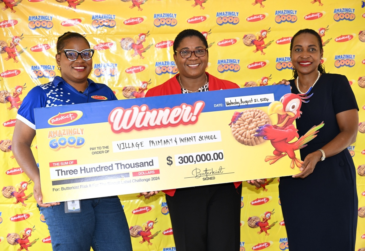 Minister of State in the Ministry of Education and Youth, Hon. Marsha Smith (right), joins Brand Manager at Seprod, Marielle Wade (left), in presenting a cheque to Principal of Village Primary and Infant School in Faiths Pen, St. Ann, Janice Nelson, on Wednesday, August 21, for winning the inaugural 'Risk It for the Biscuit' competition.

