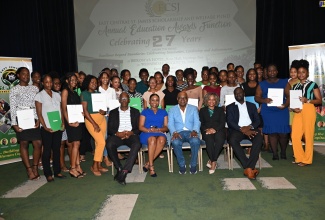 Minister without Portfolio in the Office of the Prime Minister with Responsibility for Information, Skills and Digital Transformation, Senator Dr. the Hon. Dana Morris Dixon (second right, seated), and Tourism Minister and Member of Parliament for St. James East Central, Hon. Edmund Bartlett (centre, seated), with this year’s beneficiaries of the East Central St. James Scholarship and Welfare Fund education awards. The occasion was the awards ceremony at the Iberostar Hotel in St. James on Wednesday (August 28). Joining them are Councillor for the Springmount Division, Uvel Graham (left, seated); Councillor for the Rose Hall Division, Anthony Murray (right, seated); and past grant recipient, Paige Gordon (second left, seated).