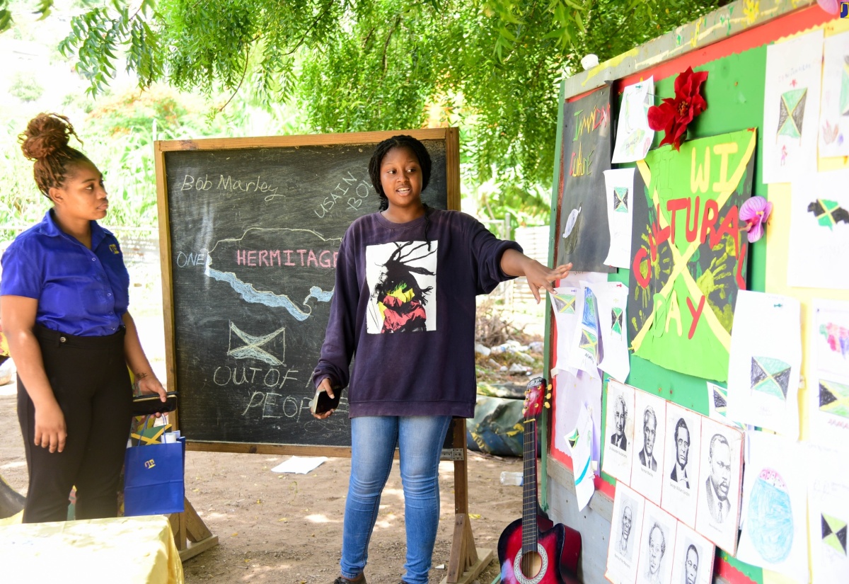 Special Projects Officer, Jamaica Information Service (JIS), Romona Geohaghan (left), is shown several pieces of artwork done by students attached to the Teach the Youth Summer Programme Centre in Hermitage, St. Andrew, by the facility’s Manager, Abygale Brown. The pieces were done for the youngsters’ ‘Culture Corner’, during their ‘Culture Day’ activity at the Centre on Tuesday (July 30). The programme, which commenced in 1999, is an annual initiative geared towards extending assistance, through academics and other interventions, to students residing in Papine and adjacent communities in St. Andrew. This year’s programme was facilitated by organisers from the University of Technology, Jamaica (UTechJa) Students’ Union Council in tandem with the JIS, under the theme ‘Empower to Inspire: Nurturing Tomorrow’s Leaders’.