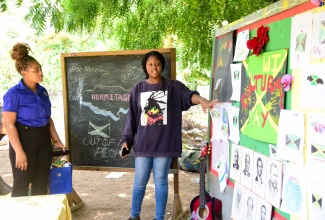 Special Projects Officer, Jamaica Information Service (JIS), Romona Geohaghan (left), is shown several pieces of artwork done by students attached to the Teach the Youth Summer Programme Centre in Hermitage, St. Andrew, by the facility’s Manager, Abygale Brown. The pieces were done for the youngsters’ ‘Culture Corner’, during their ‘Culture Day’ activity at the Centre on Tuesday (July 30). The programme, which commenced in 1999, is an annual initiative geared towards extending assistance, through academics and other interventions, to students residing in Papine and adjacent communities in St. Andrew. This year’s programme was facilitated by organisers from the University of Technology, Jamaica (UTechJa) Students’ Union Council in tandem with the JIS, under the theme ‘Empower to Inspire: Nurturing Tomorrow’s Leaders’.