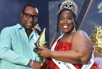 Supernumerary Permanent Secretary in the Ministry of Culture, Gender, Entertainment and Sport, Dean-Roy Bernard, presents a trophy to Miss Jamaica Festival Queen 2024, Omolora Wilson (right), during the coronation ceremony held at Independence Village in Kingston on Saturday (August 3).