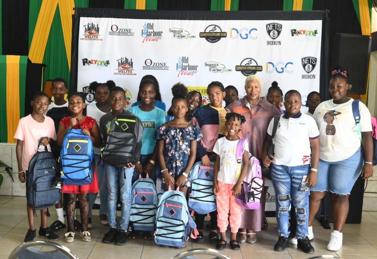 Executive Director, Pollyanna Project, Donna Stewart Moore (fifth right), with some of the students who recently got educational support from the organisation, at an event held at the Lions Civic Centre in Old Harbour, St. Catherine.

